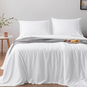Organic bamboo duvet cover set in pure white, featuring pillowcases and a bamboo sleep mask.