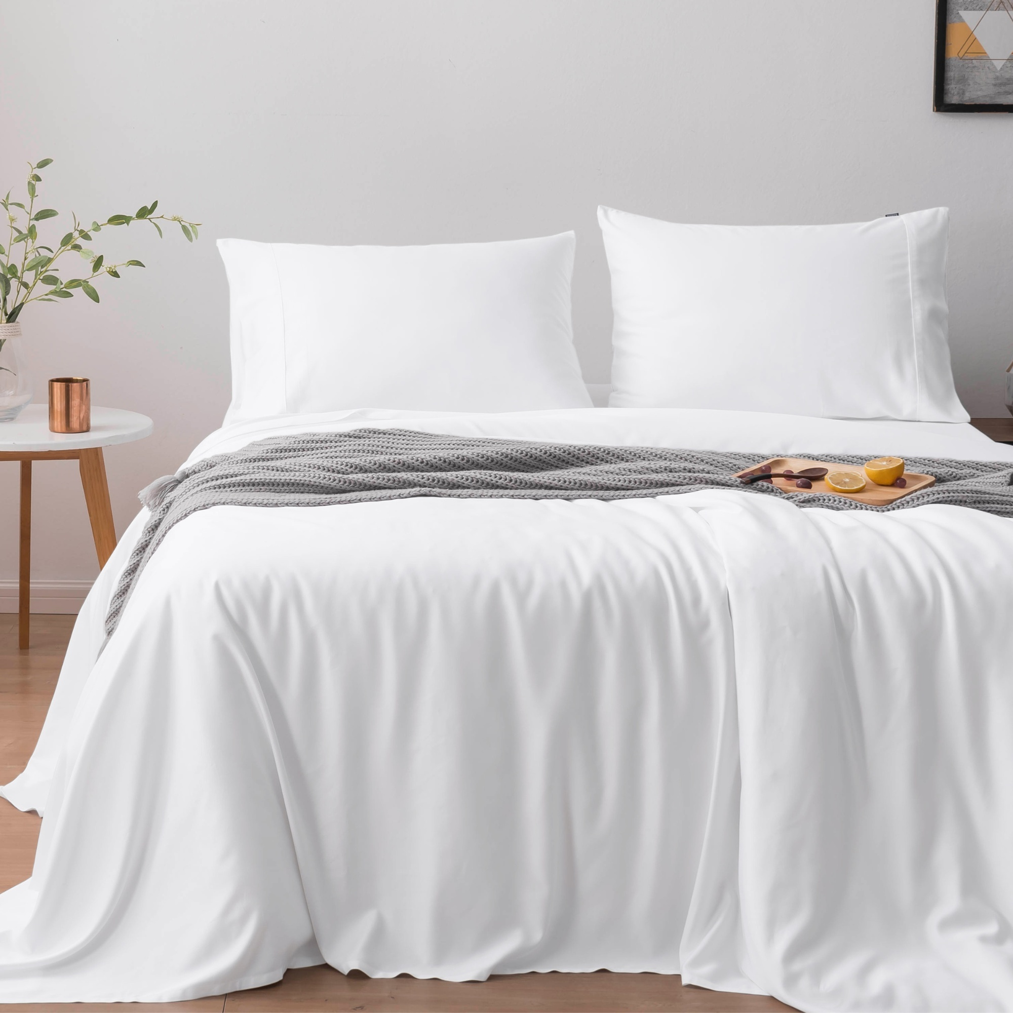 Organic bamboo duvet cover set in pure white, featuring pillowcases and a bamboo sleep mask.