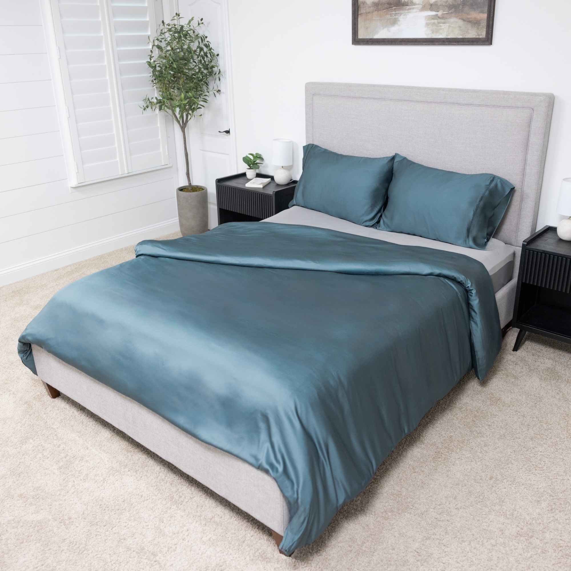 Ocean blue organic bamboo duvet cover set on bed with pillowcases, featuring soft, luxurious fabric for rejuvenating sleep.