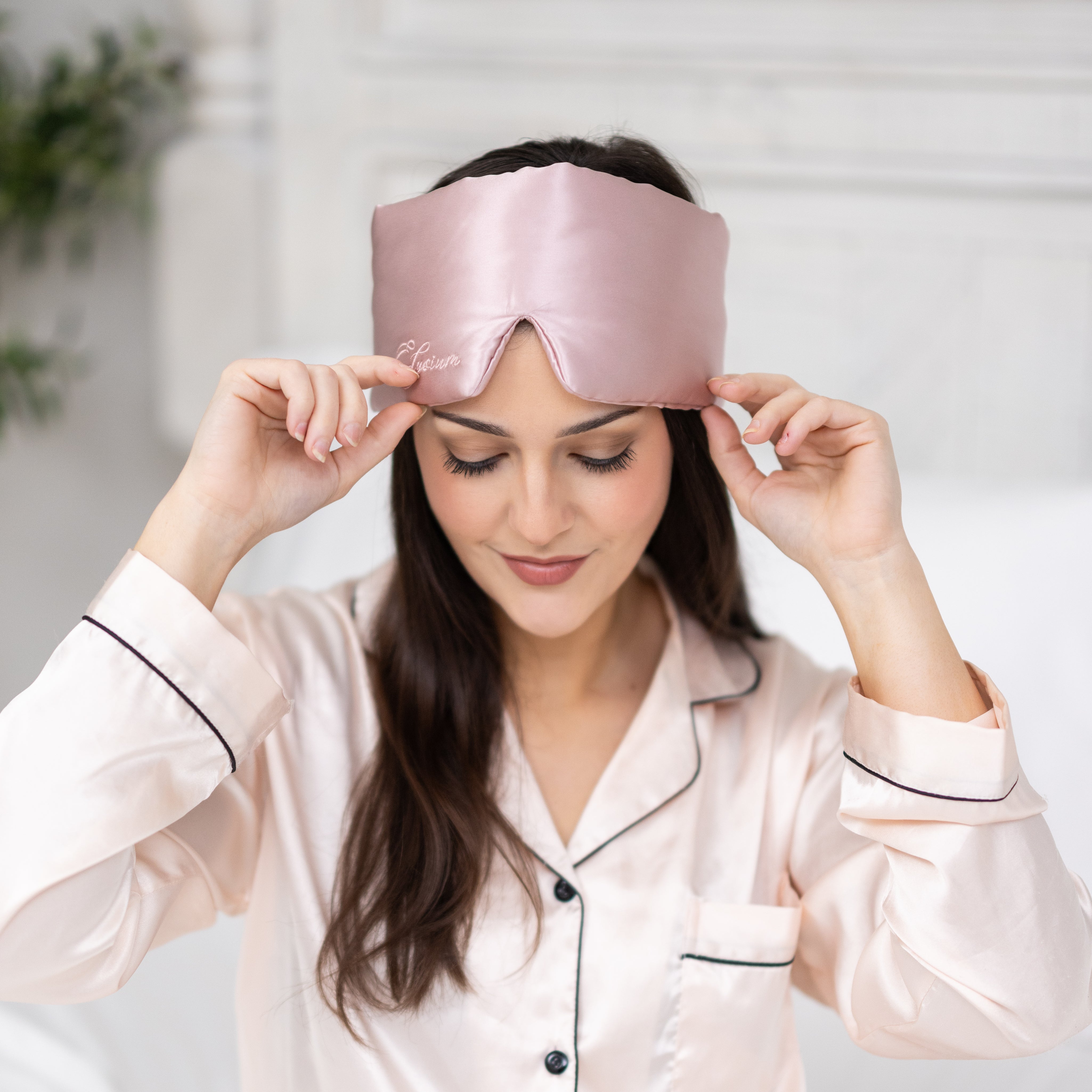 Young woman wearing silk sleep mask preparing for deep sleep