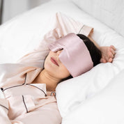 Woman falling sleeping with Elysium Silk Eye Mask for eyes in Pink