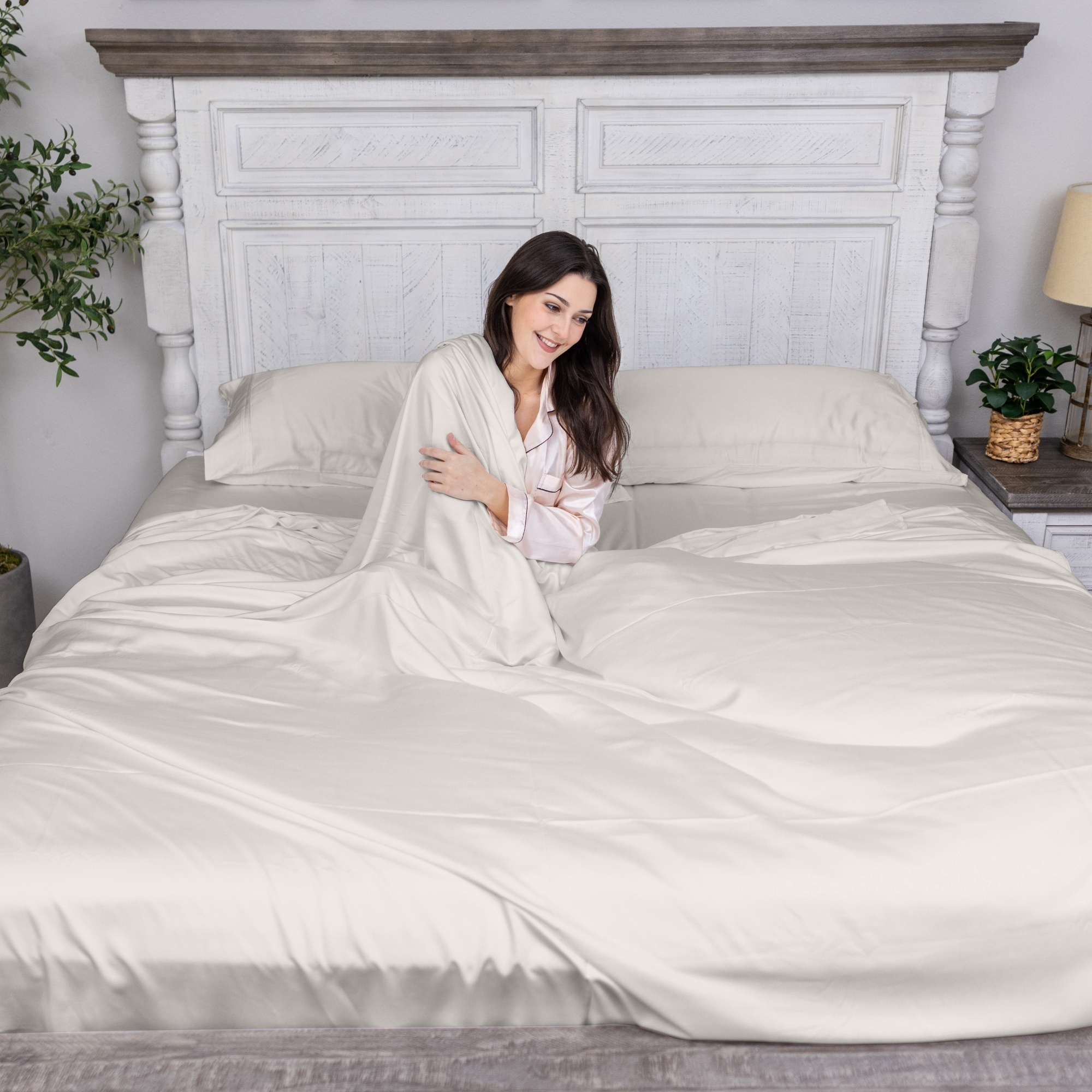 Young woman relaxing with bamboo bedding set in Ivory