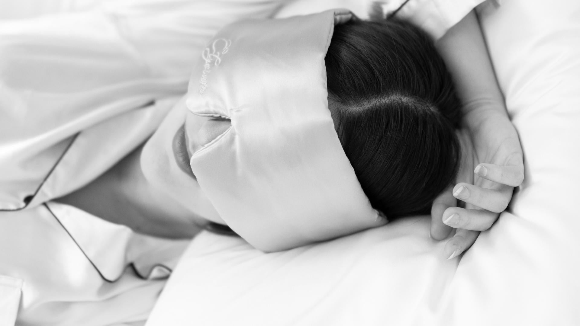 Young woman sleeping with a silk sleep mask