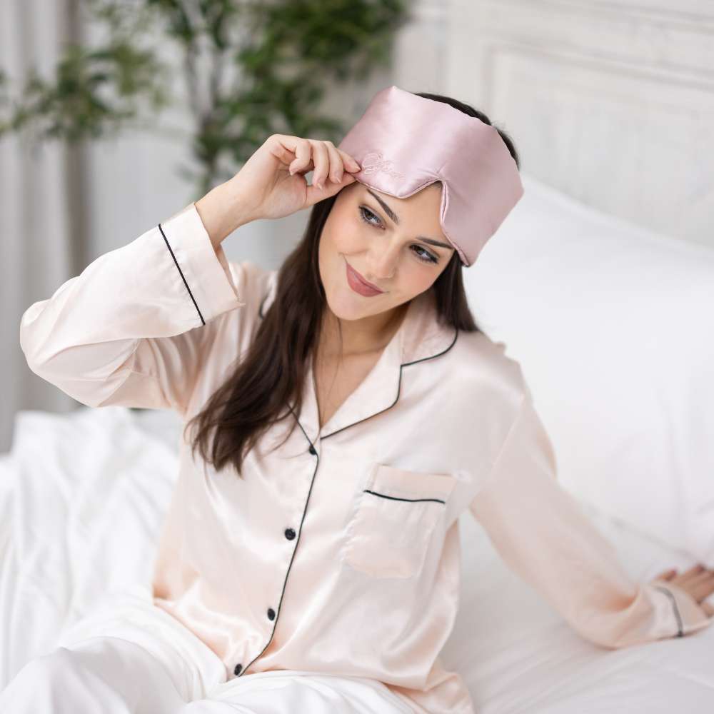young woman waking up wearing a luxury sleep mask